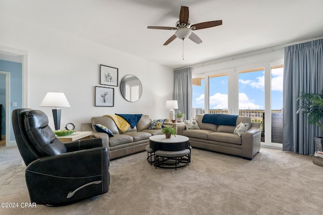 carpeted living area featuring ceiling fan