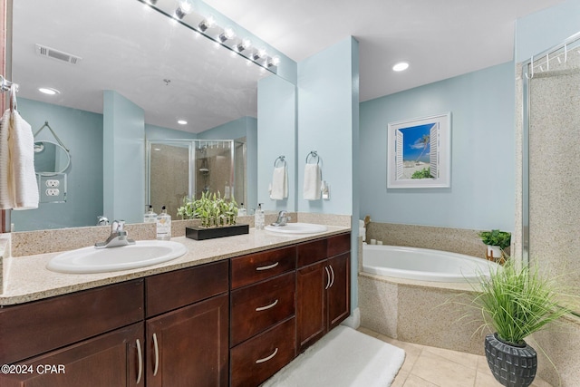 bathroom with a garden tub, a shower stall, visible vents, and a sink