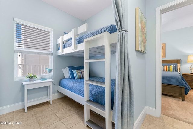 bedroom featuring light tile patterned floors and baseboards