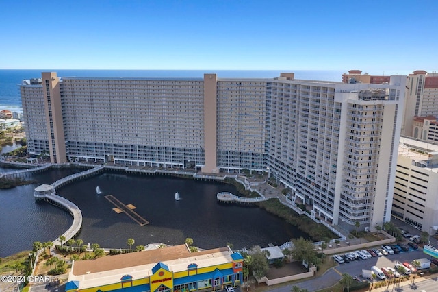 birds eye view of property featuring a view of city and a water view