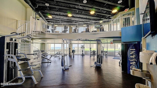 gym featuring a towering ceiling