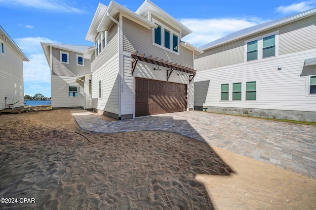 view of front facade with a patio area and a garage