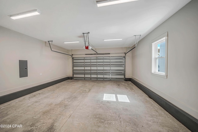 garage featuring a garage door opener and electric panel