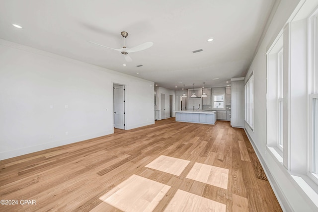 unfurnished living room with light hardwood / wood-style floors and ceiling fan