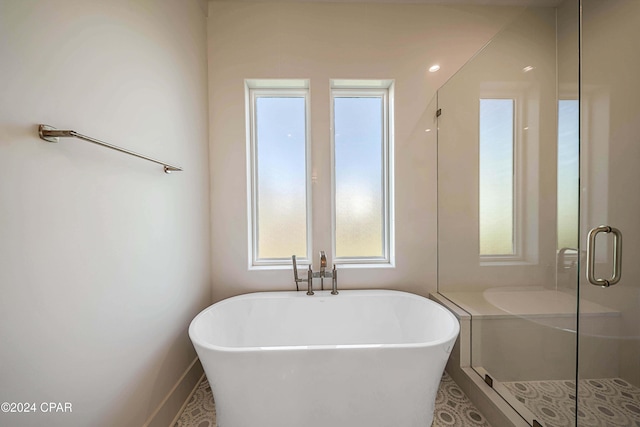 bathroom featuring separate shower and tub