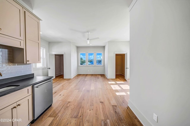 kitchen featuring light hardwood / wood-style flooring, tasteful backsplash, dishwasher, and plenty of natural light