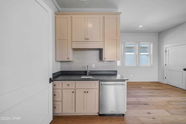 kitchen with decorative backsplash, dishwasher, cream cabinetry, light hardwood / wood-style floors, and sink