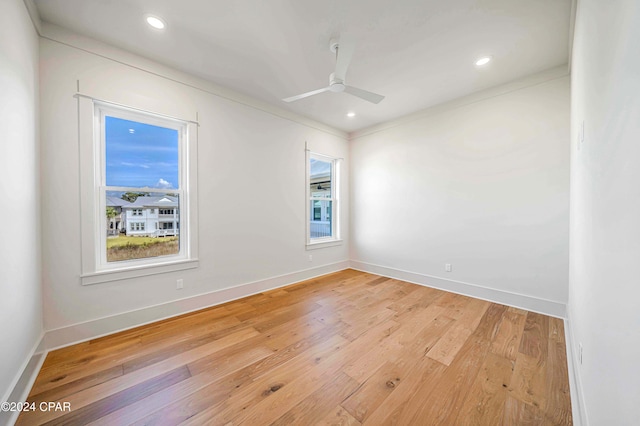 unfurnished room featuring ceiling fan, crown molding, and light wood-type flooring