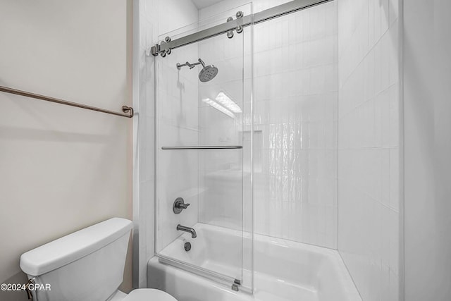 bathroom featuring toilet and enclosed tub / shower combo