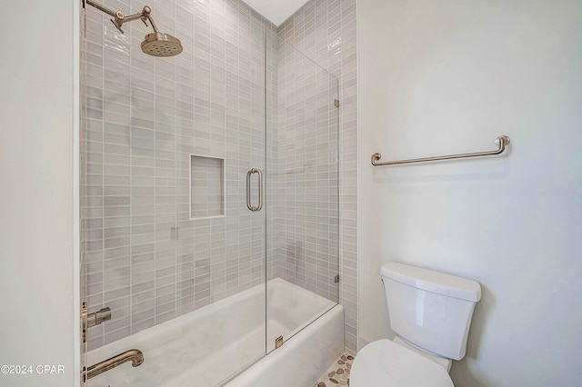 bathroom featuring toilet and enclosed tub / shower combo