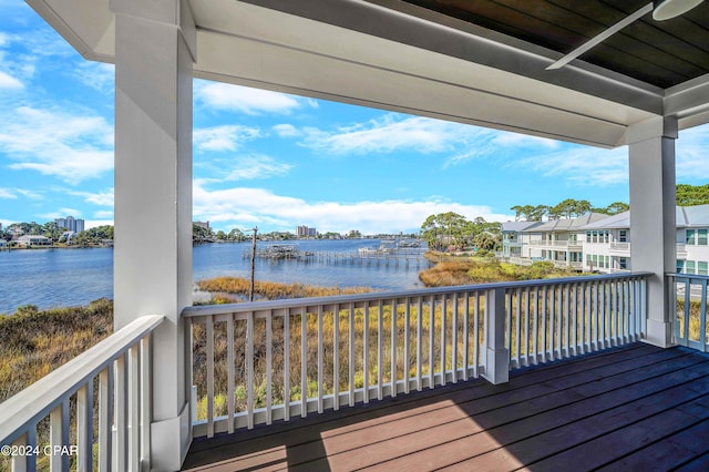 wooden terrace featuring a water view