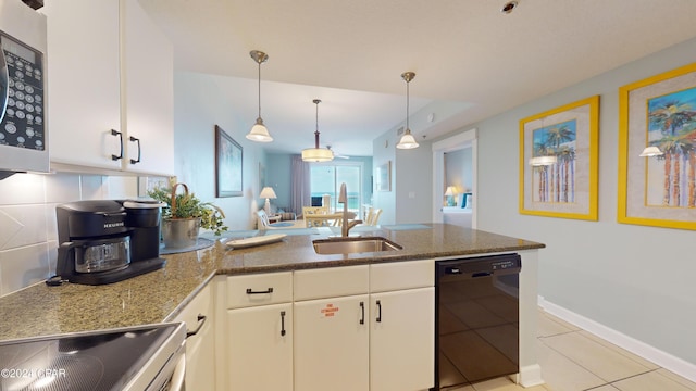 kitchen with black dishwasher, stainless steel microwave, backsplash, stove, and a peninsula