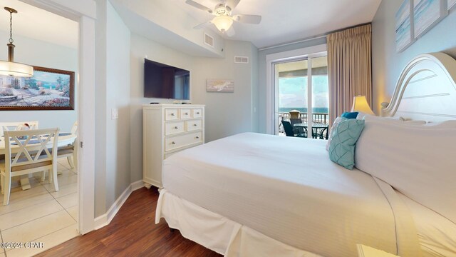 11800 Front Beach Rd Unit 2-504, Panama City Beach, FL 32407 - bedroom featuring access to exterior, dark wood-type flooring, baseboards, and a ceiling fan