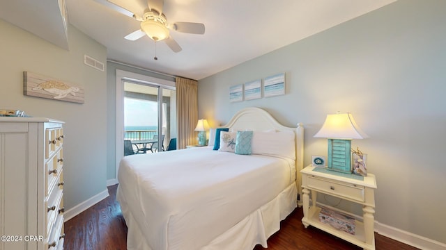 bedroom with access to outside, dark wood-style flooring, visible vents, and baseboards