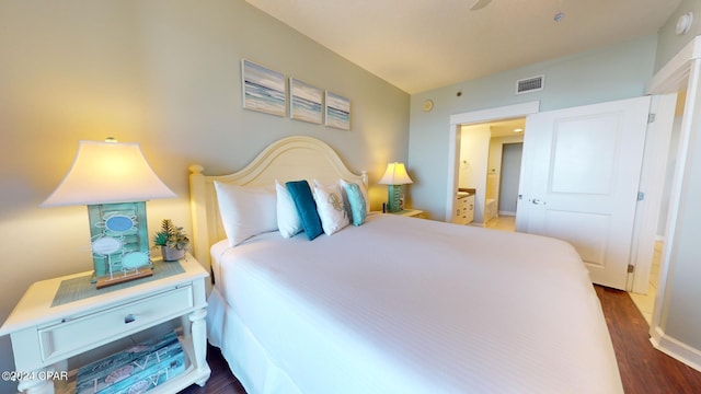 bedroom featuring wood finished floors and visible vents