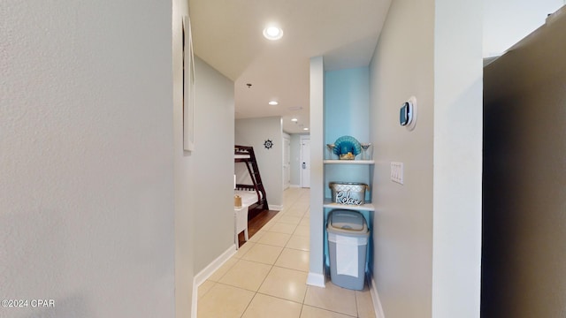 corridor with recessed lighting, baseboards, and light tile patterned floors