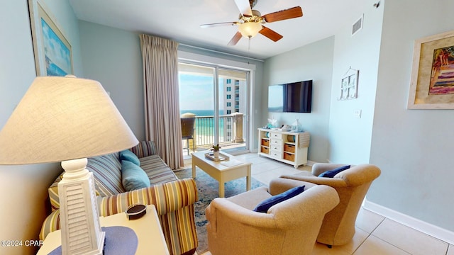 living room featuring baseboards, tile patterned flooring, visible vents, and a ceiling fan