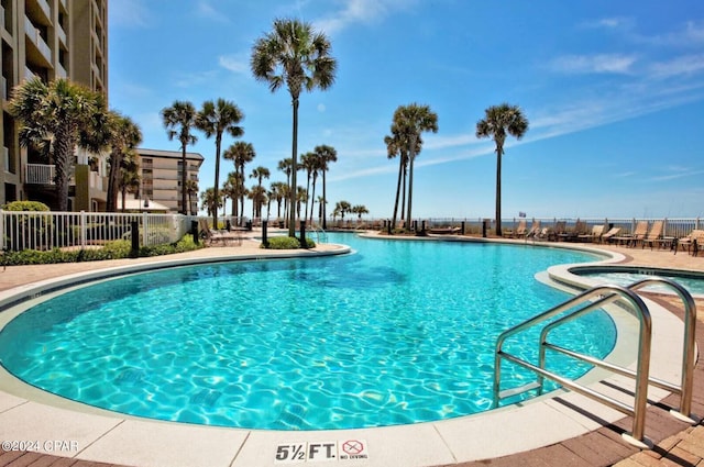 community pool featuring a patio and fence