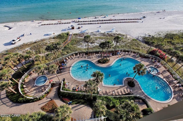 birds eye view of property with a water view and a view of the beach