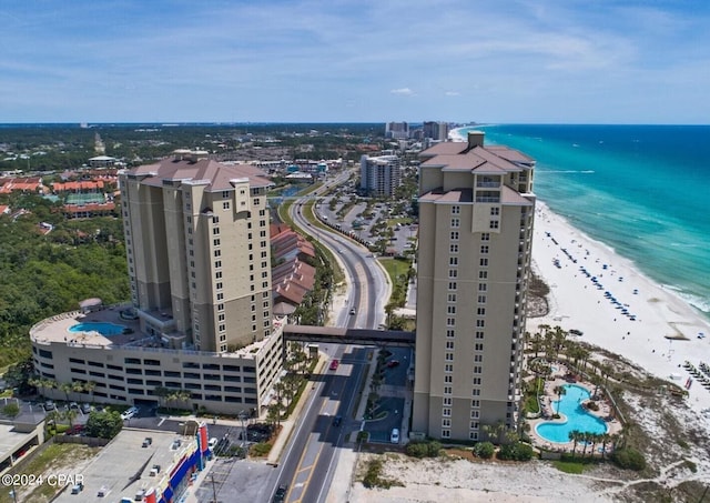 birds eye view of property featuring a view of the beach, a water view, and a view of city