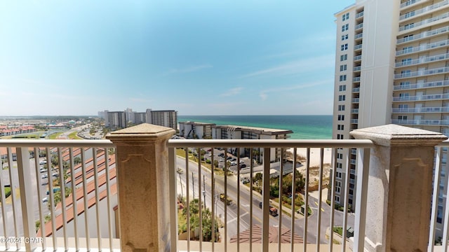 balcony featuring a water view and a city view