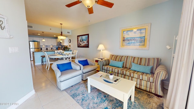 living room with light tile patterned floors, visible vents, and a ceiling fan