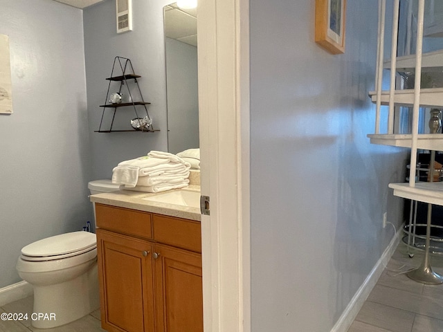 bathroom with tile patterned floors, vanity, and toilet