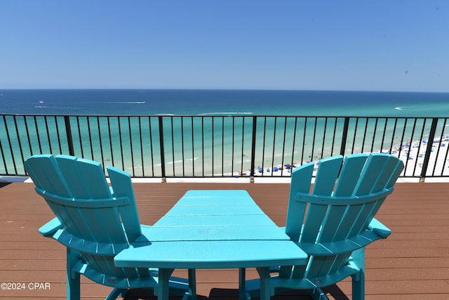 deck with a water view and a view of the beach