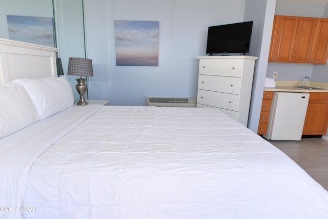 bedroom featuring light tile patterned flooring and sink