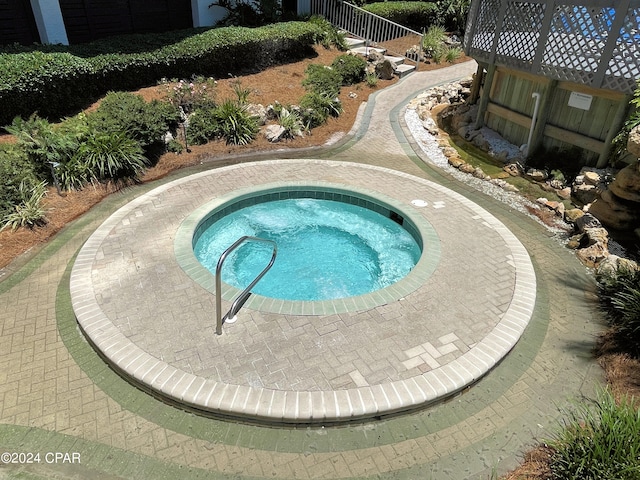 view of pool with an in ground hot tub