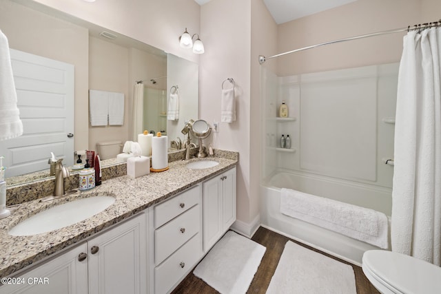 full bathroom with shower / bath combo with shower curtain, oversized vanity, wood-type flooring, toilet, and dual sinks