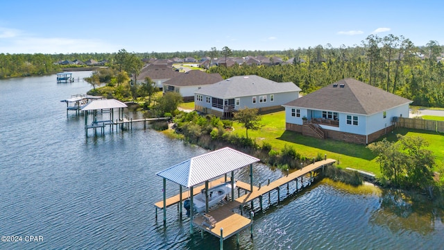 dock area featuring a lawn and a water view