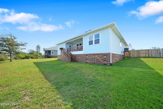 rear view of property with a yard