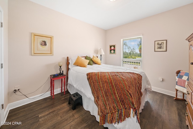 bedroom with dark hardwood / wood-style floors