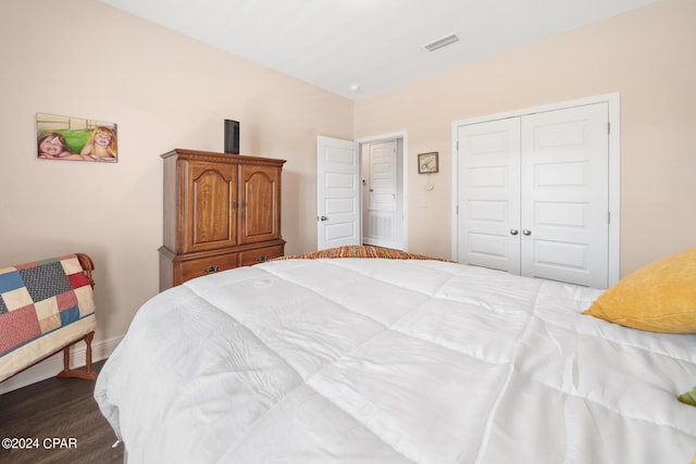 bedroom featuring dark hardwood / wood-style flooring and a closet