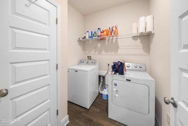 clothes washing area with washer and dryer, hookup for a washing machine, and dark hardwood / wood-style flooring