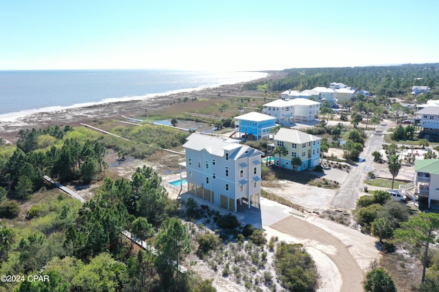 birds eye view of property with a view of the beach and a water view