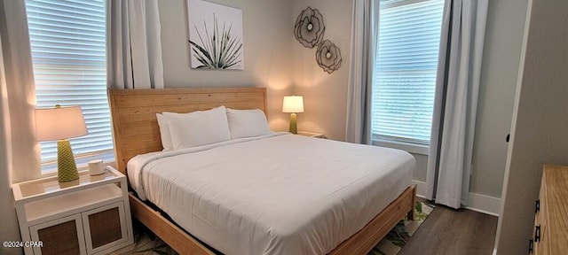 bedroom with dark hardwood / wood-style flooring