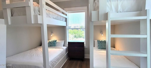 bedroom with dark wood-type flooring