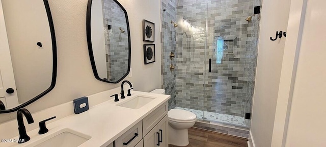 bathroom featuring vanity, toilet, an enclosed shower, and wood-type flooring