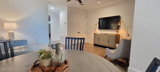 dining room with light hardwood / wood-style floors and ceiling fan