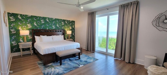 bedroom with access to exterior, ceiling fan, and hardwood / wood-style floors