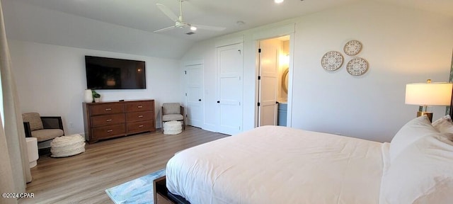 bedroom featuring hardwood / wood-style floors, vaulted ceiling, and ceiling fan