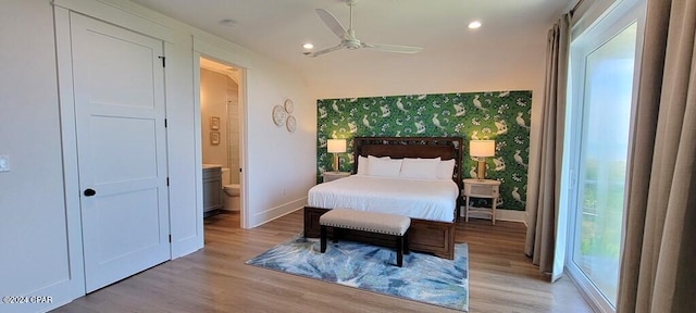 bedroom with light wood-type flooring, ensuite bathroom, and ceiling fan