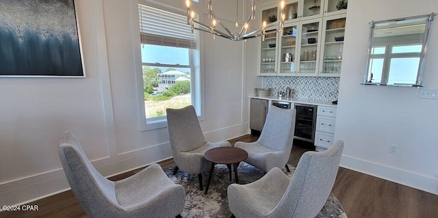 interior space featuring a chandelier, dark hardwood / wood-style flooring, wine cooler, and bar area