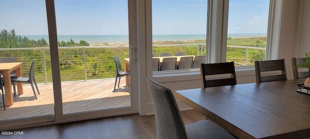 doorway to outside with hardwood / wood-style floors and a water view