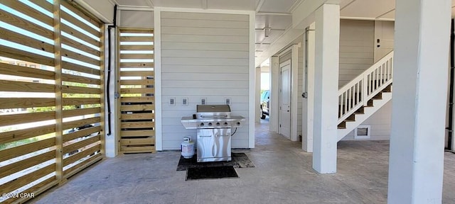 interior space with concrete floors and wood walls