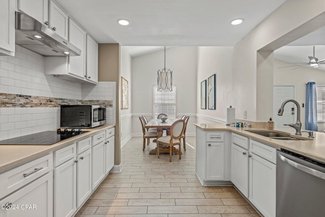 kitchen with white cabinets, decorative light fixtures, stainless steel appliances, and sink