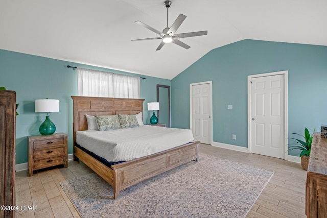 bedroom featuring light hardwood / wood-style flooring, ceiling fan, and lofted ceiling