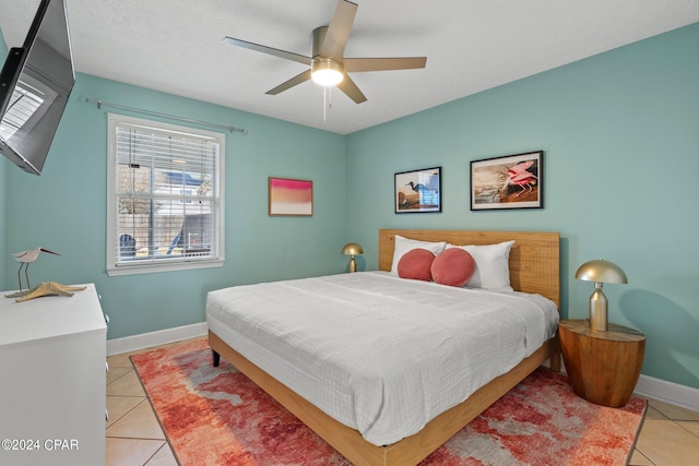 tiled bedroom with ceiling fan